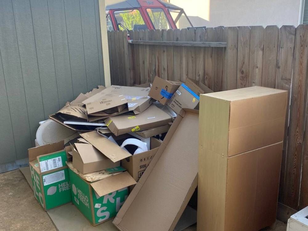 Cluttered shed area with boxes before Dump Ninja shed removal in Woodland, CA