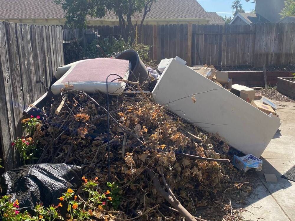 Before: a pile of dirt and debris in a side yard