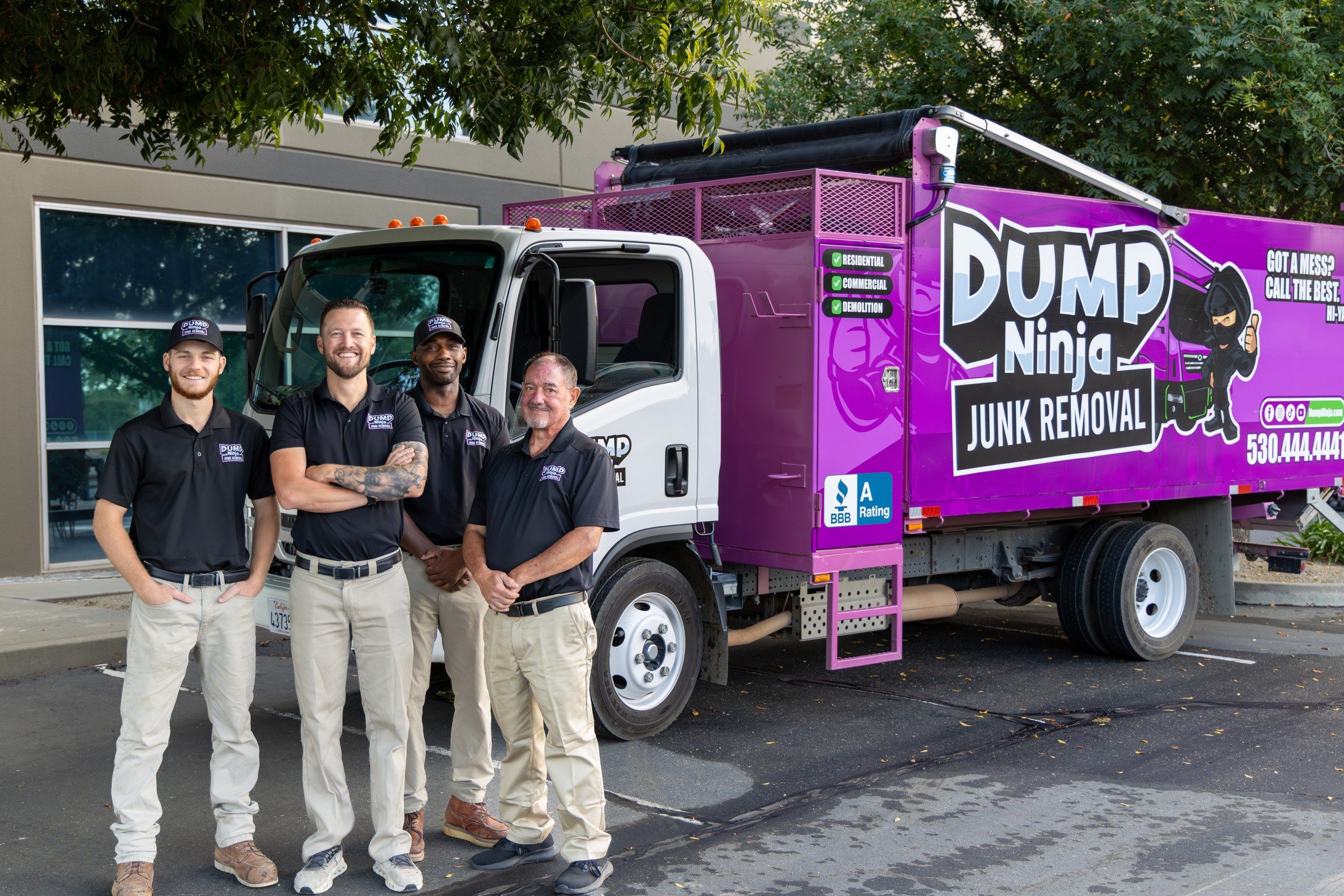 The Dump Ninja crew standing with the 21-yard truck outside the Woodland shop