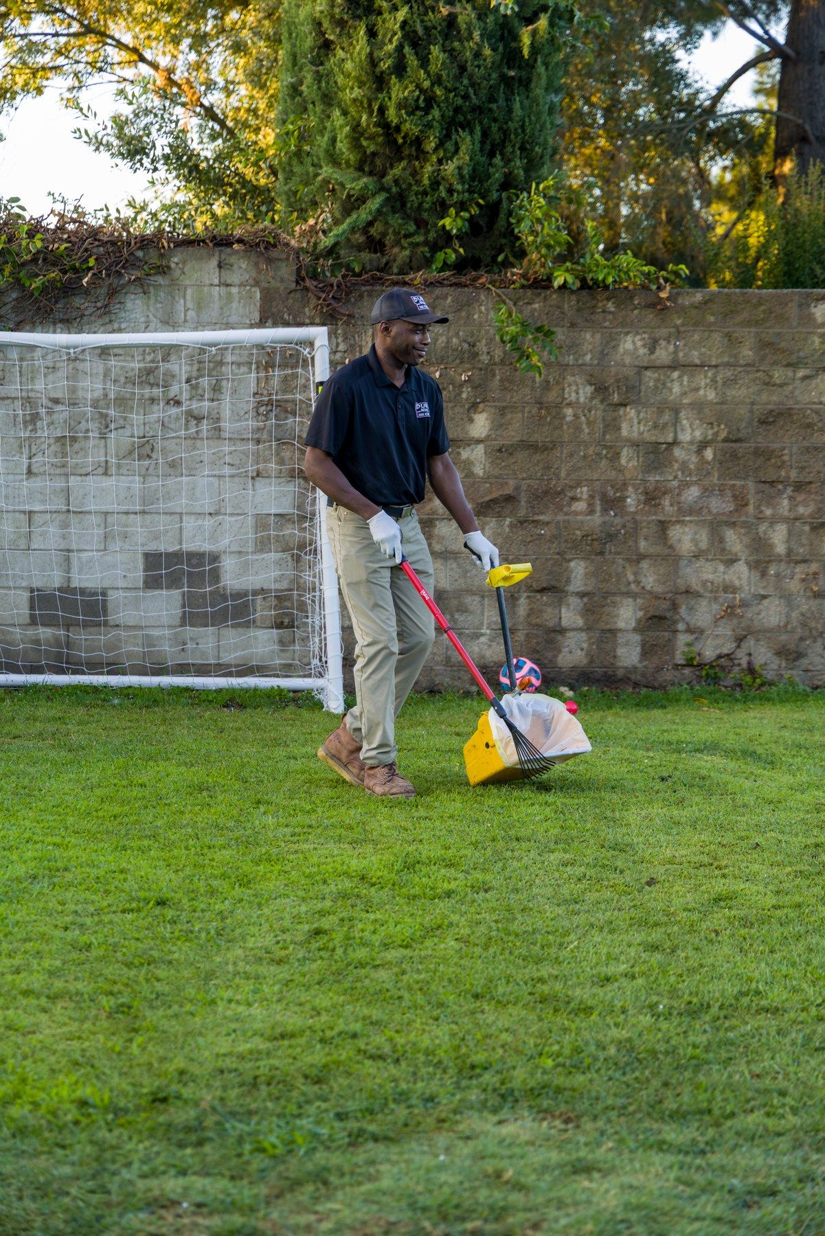 Dump Ninja crew member on a shared apartment lawn beside a soccer goal in Woodland