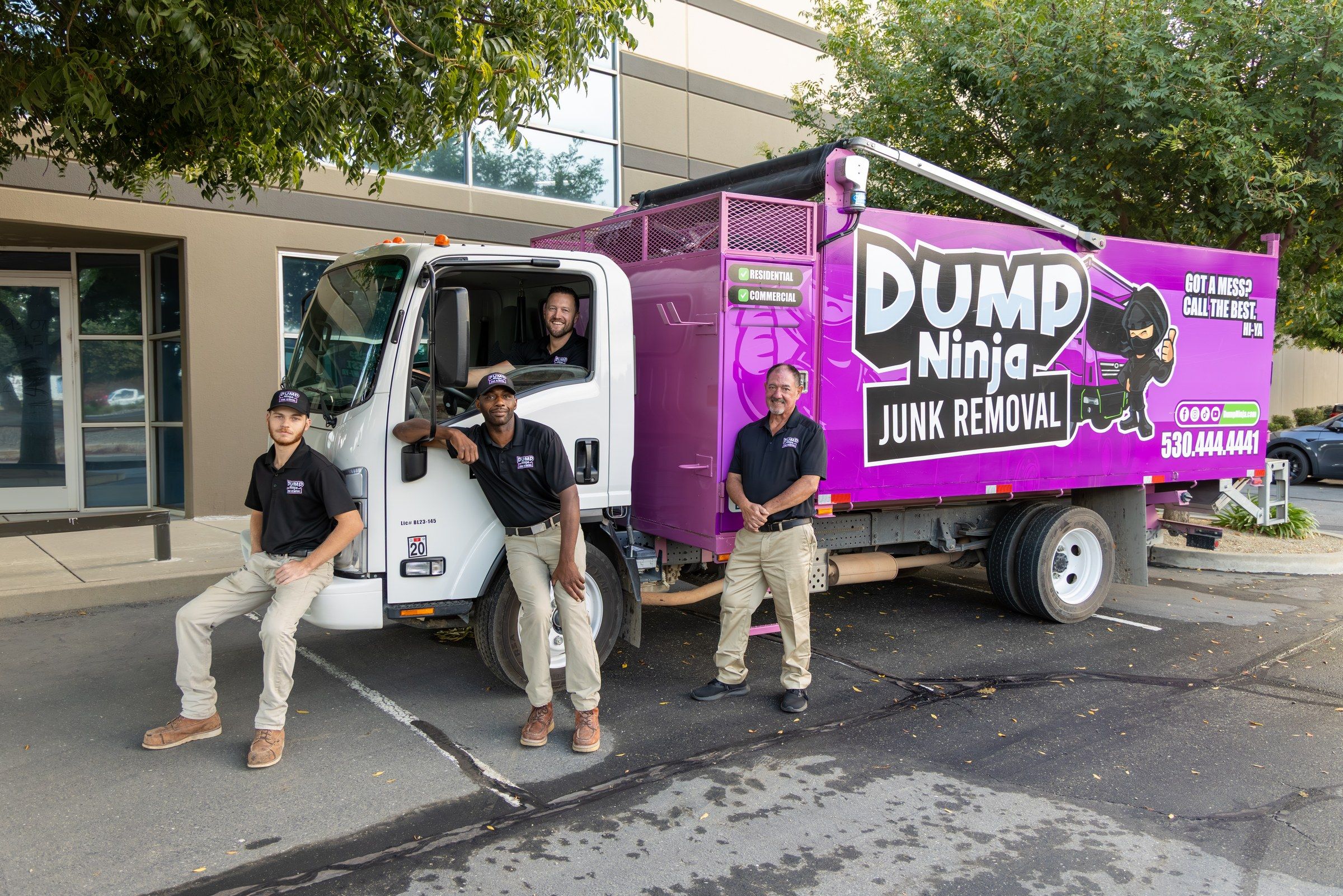 Dump Ninja crew with the company’s magenta hauling truck